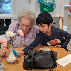 Volunteering holding old lady’s hands